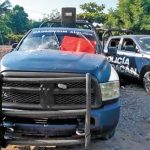 A red narco-banner on one of the vehicles in which state police officers were killed.