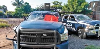 A red narco-banner on one of the vehicles in which state police officers were killed.