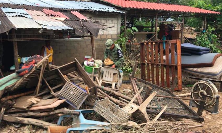 A National Guardsmen provides aid to flood victims.