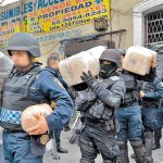 Police remove drugs from a Mexico City property after a raid on the Unión de Tepito.
