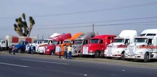 Striking truckers park their rigs at the roadside on Tuesday.