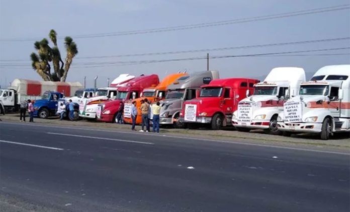 Striking truckers park their rigs at the roadside on Tuesday.