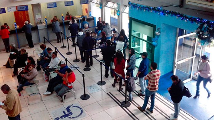 Water customers line up to pay their bills in Morelia, but many don't bother.