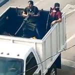 Cartel gunmen with a machine gun mounted in the back of a truck