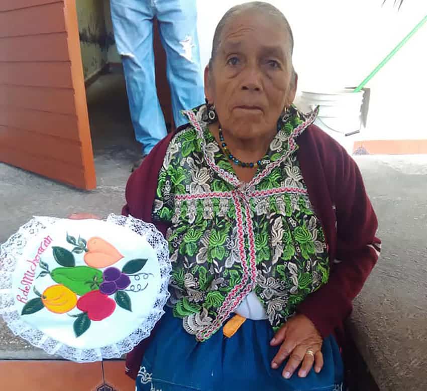 Doña Adela and her embroidery.