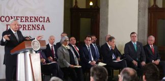Cabinet secretaries listen as President López Obrador presents infrastructure plan.