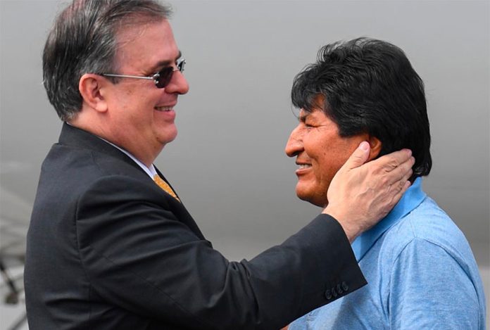 Foreign Secretary Ebrard, left, greets Bolivia's Evo Morales in Mexico City.