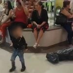 Boy in a 'narco-ween' costume, complete with plastic body bag.