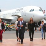 The president walks to the terminal building after a flight with Volaris.