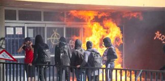 Vandals start a fire at a university bookstore on Thursday.