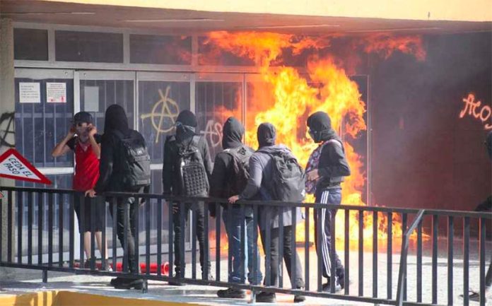 Vandals start a fire at a university bookstore on Thursday.