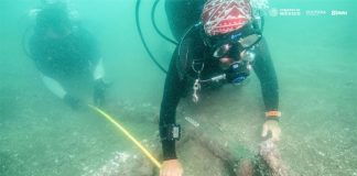 Divers measure one of the anchors found off Veracruz.