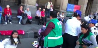 City officials clear vendors from the street on Sunday.