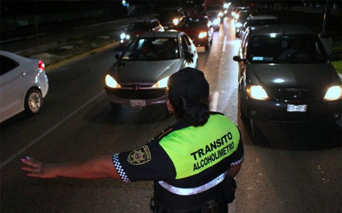 A traffic cop at a breath test stop in Cancún.