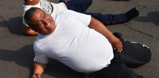 An officer grimaces over the pain of exercise.