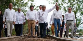 The president and other officials on tracks to be occupied by the new train.