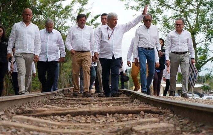 The president and other officials on tracks to be occupied by the new train.