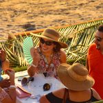 Guests enjoy wine festival on the beach at Zihuatanejo.