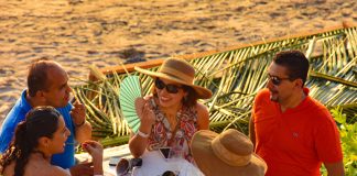 Guests enjoy wine festival on the beach at Zihuatanejo.