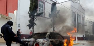 A vehicle burns during Thursday's protest in Amozoc.