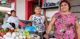 Flora, right, at her fruit and vegetable stand in Tenabo, Campeche.