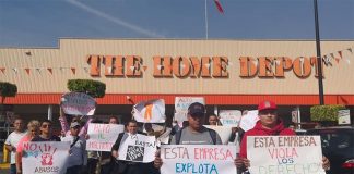 Workers protest outside a Home Depot in Mexico City.