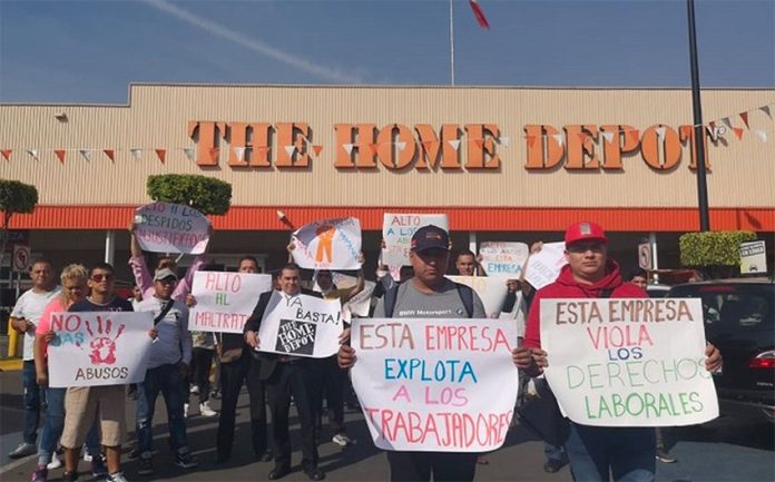 Workers protest outside a Home Depot in Mexico City.