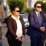 Hotel staff are taken away by police after their arrest for kidnapping.