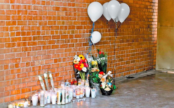 A memorial at the school where two people were killed and six wounded.