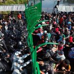 National Guardsmen close the gates on migrants at the southern border.