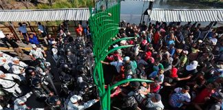 National Guardsmen close the gates on migrants at the southern border.