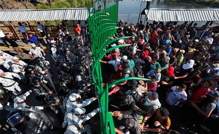National Guardsmen close the gates on migrants at the southern border.