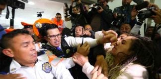 Police scuffle with parents protesting a shortage of cancer drugs.