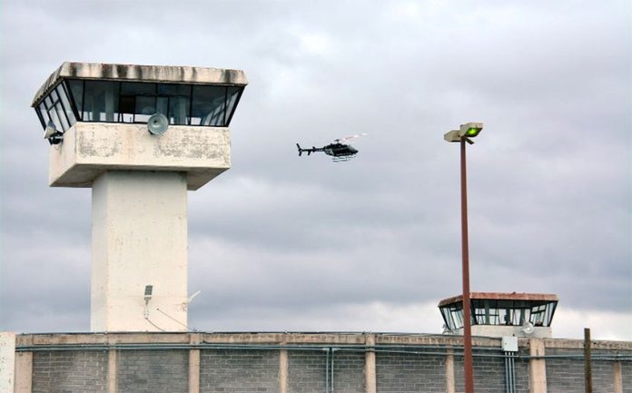 A helicopter flies over the Zacatecas prison where two riots have occurred this week.