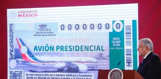 The president presents raffle ticket design at today's press conference.