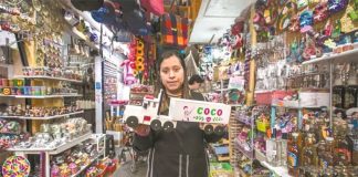 Toy vendor Rosario with a truck bearing the name of a popular film.