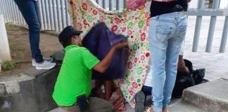 A woman gives birth outside a health clinic in Aquila.