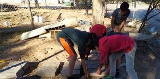 Youths at work on their building blocks.