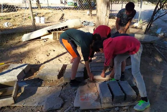 Youths at work on their building blocks.