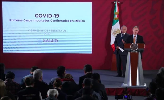 President López Obrador looks on as Deputy Health Minister López-Gatell announces the coronavirus cases.