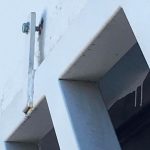 A screw that has pulled out of the wall at housing project.