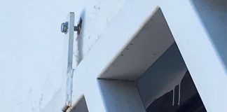 A screw that has pulled out of the wall at housing project.