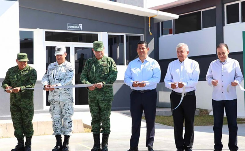 The ribbon is cut at new barracks for the National Guard.