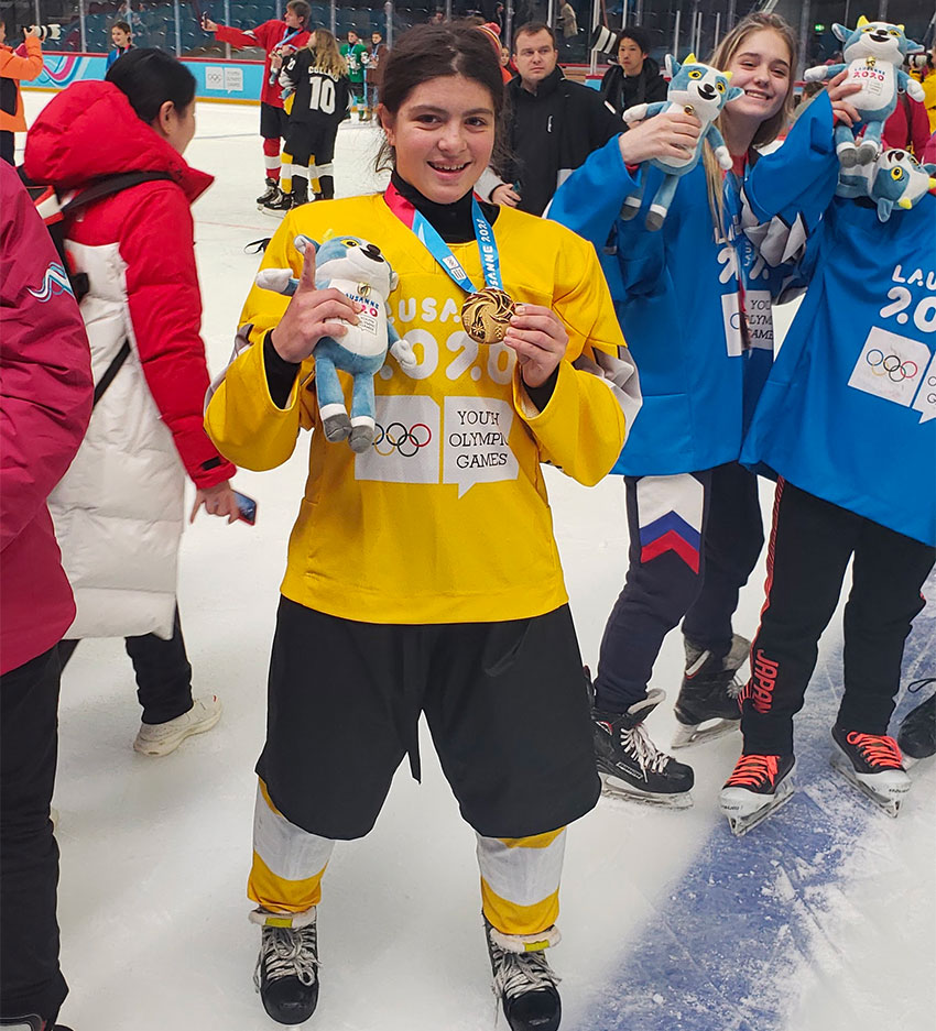 Hockey player Wilson with her gold medal.