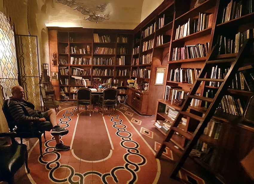 A visitor enjoys a quiet moment in the library, which is filled with books on art.