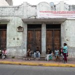 Asylum seekers wait outside the COMAR offices in the center of Tapachula.