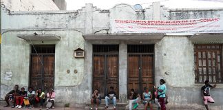Asylum seekers wait outside the COMAR offices in the center of Tapachula.