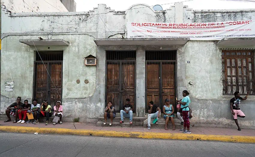 Asylum seekers wait outside the COMAR offices in the center of Tapachula.