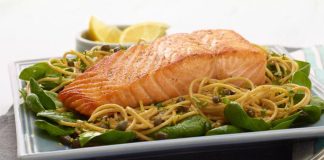 Salmon with basil in a pasta dish.