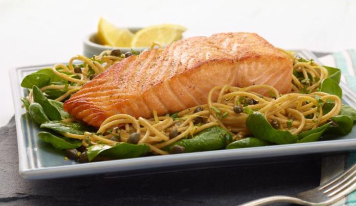 Salmon with basil in a pasta dish.